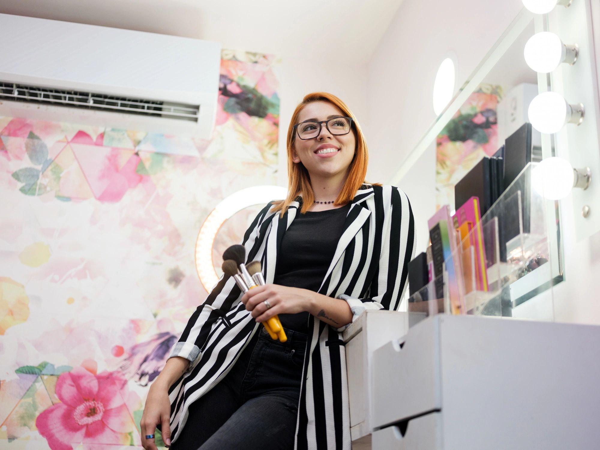 Professional makeup artist smiling in a beauty studio